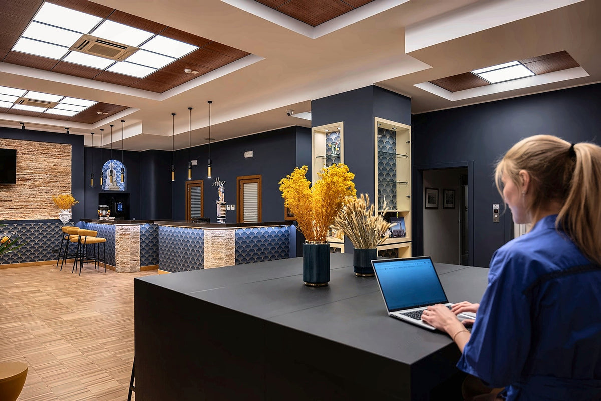 The entrance hall of Hotel Moderno, with skylights and a blue-tiled reception