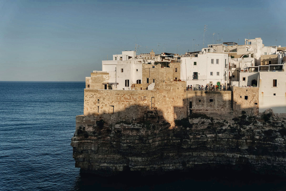 Polignano a Mare on its cliffs in the last sun, a short train ride from Bari