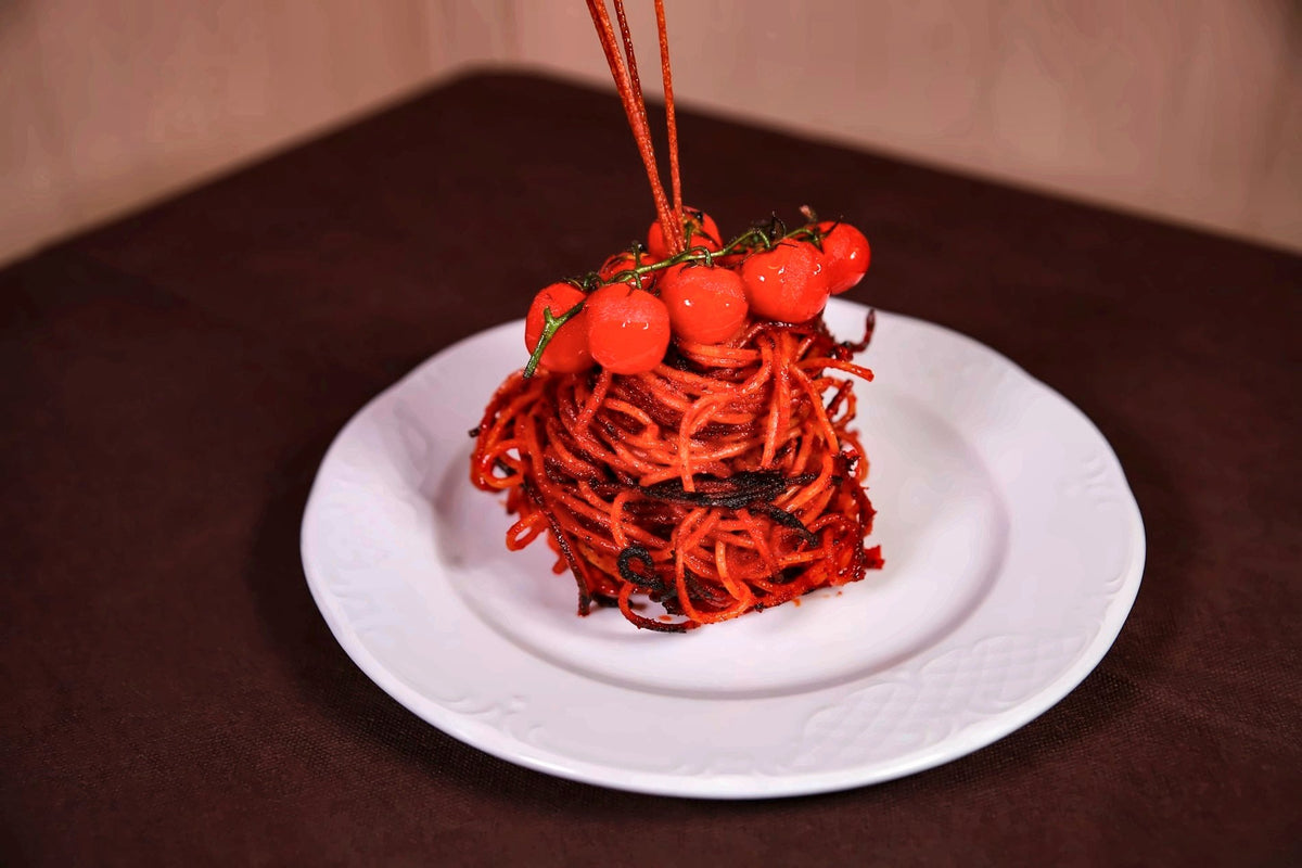 A nest of tomato spaghetti crowned with cherry tomatoes at La Baresana