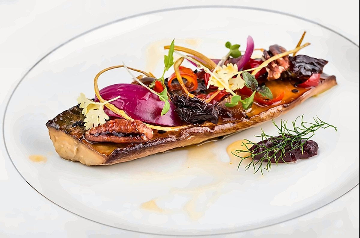 A colourful plated main course with fresh herbs at La Bul