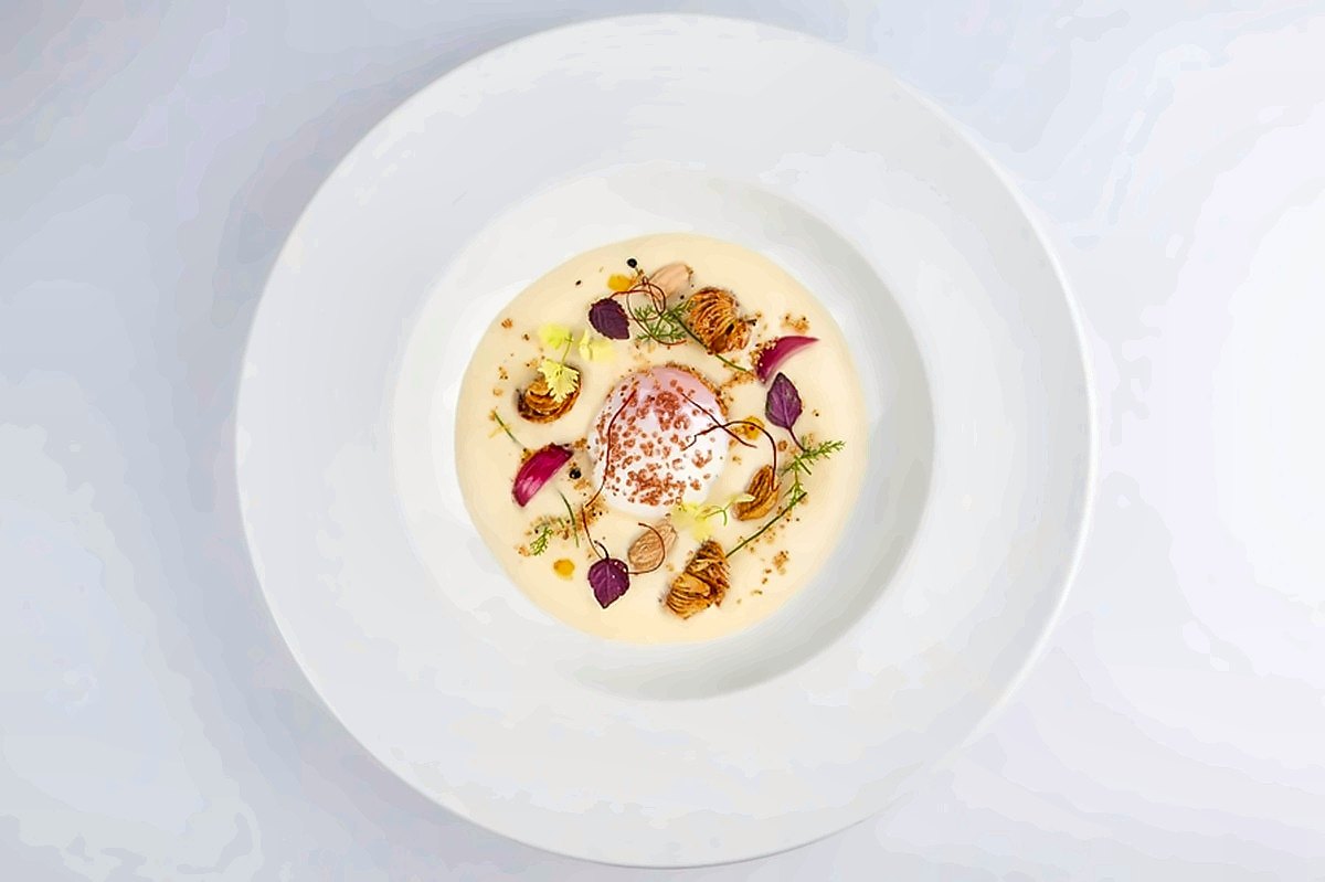 A delicate first course in a wide white bowl at La Bul