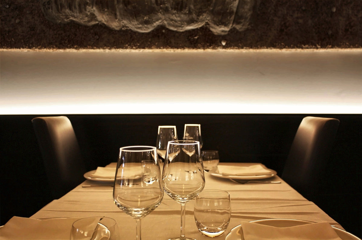 Glasses set on a softly lit table at La Muraya