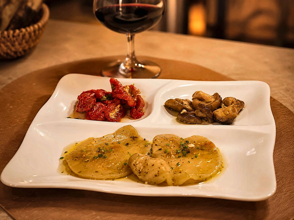 A platter of Bari specialities with a glass of red at Al Raffaello