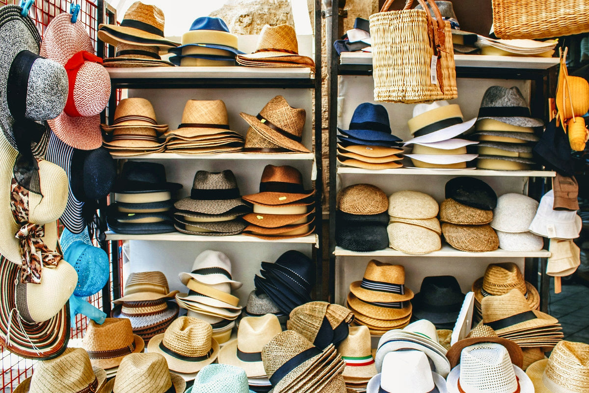 Straw hats stacked high in a shop in Bari Vecchia