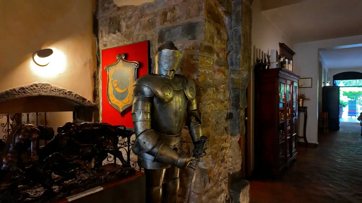 Stone-walled interior with a suit of armour at Da Mimmo