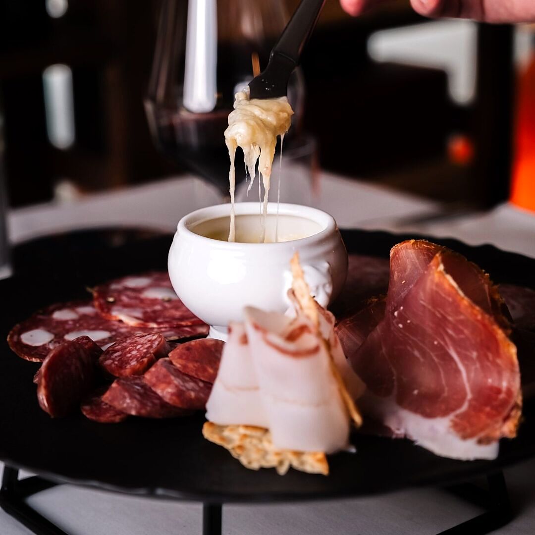 Cured meats with a melted-cheese pot at La Fricca