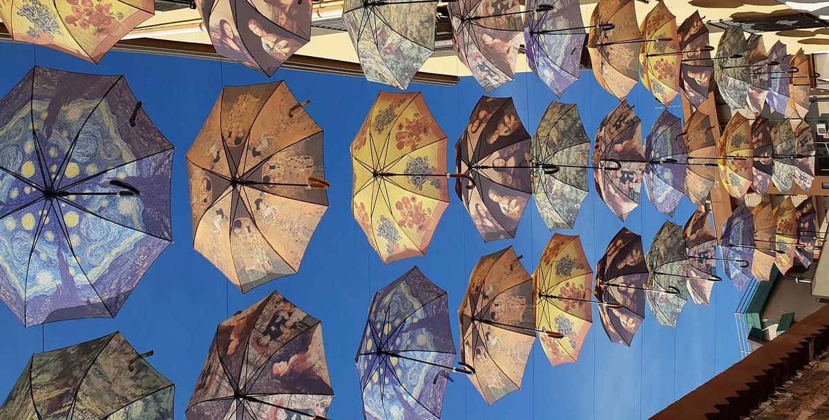 Painted umbrella installation above the courtyard at Art & Jazz Hotel