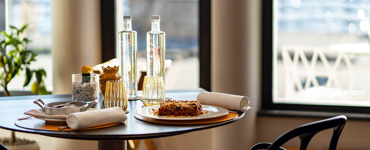 Table by the window with a plated dish at Faraglioni Restaurant