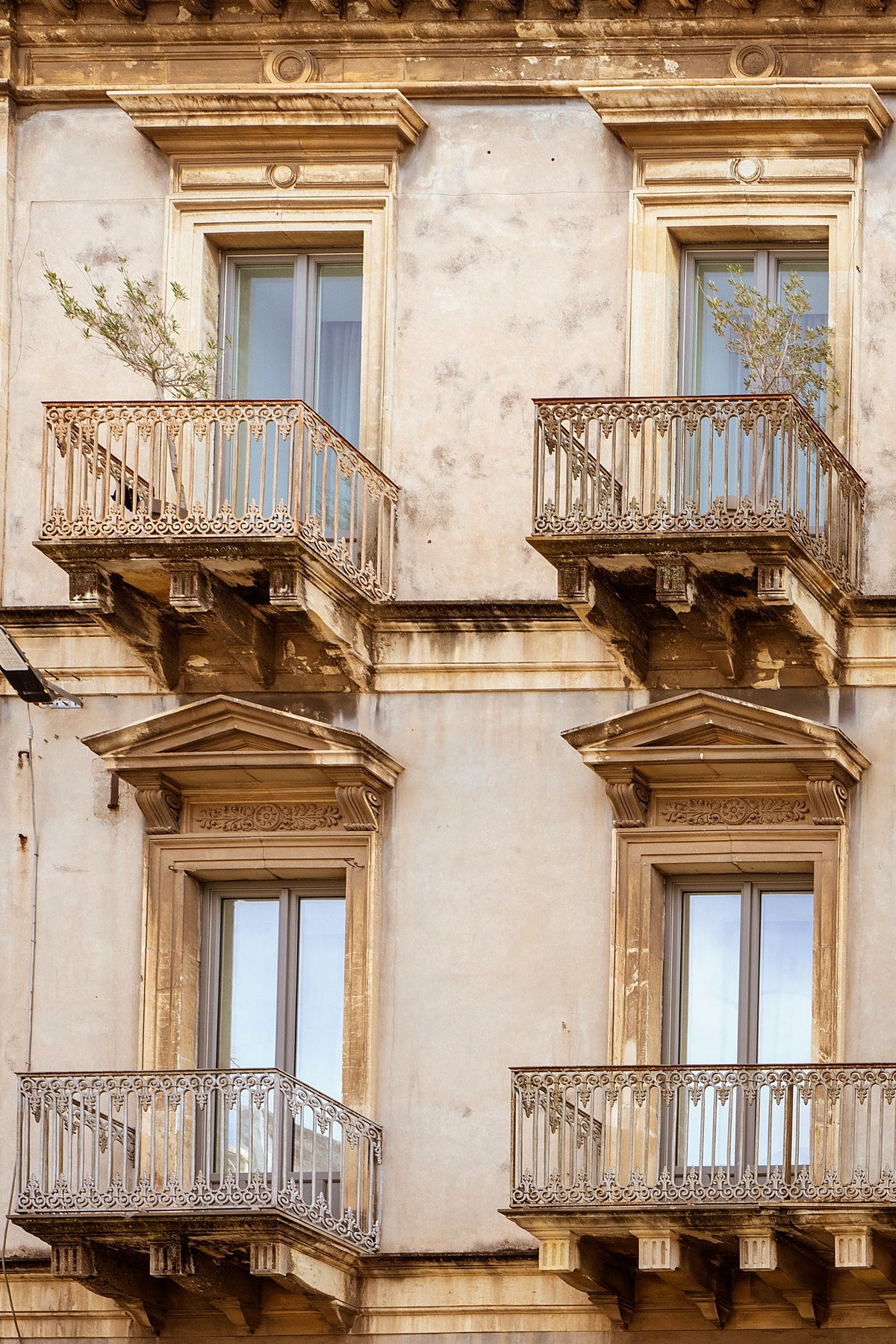 Baroque stone façade with wrought-iron balconies at Habitat Boutique Hotel