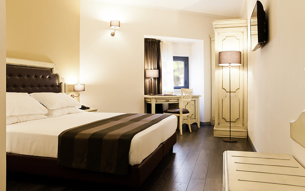 Premium room with dark wood floor and classic furnishings at Manganelli Palace