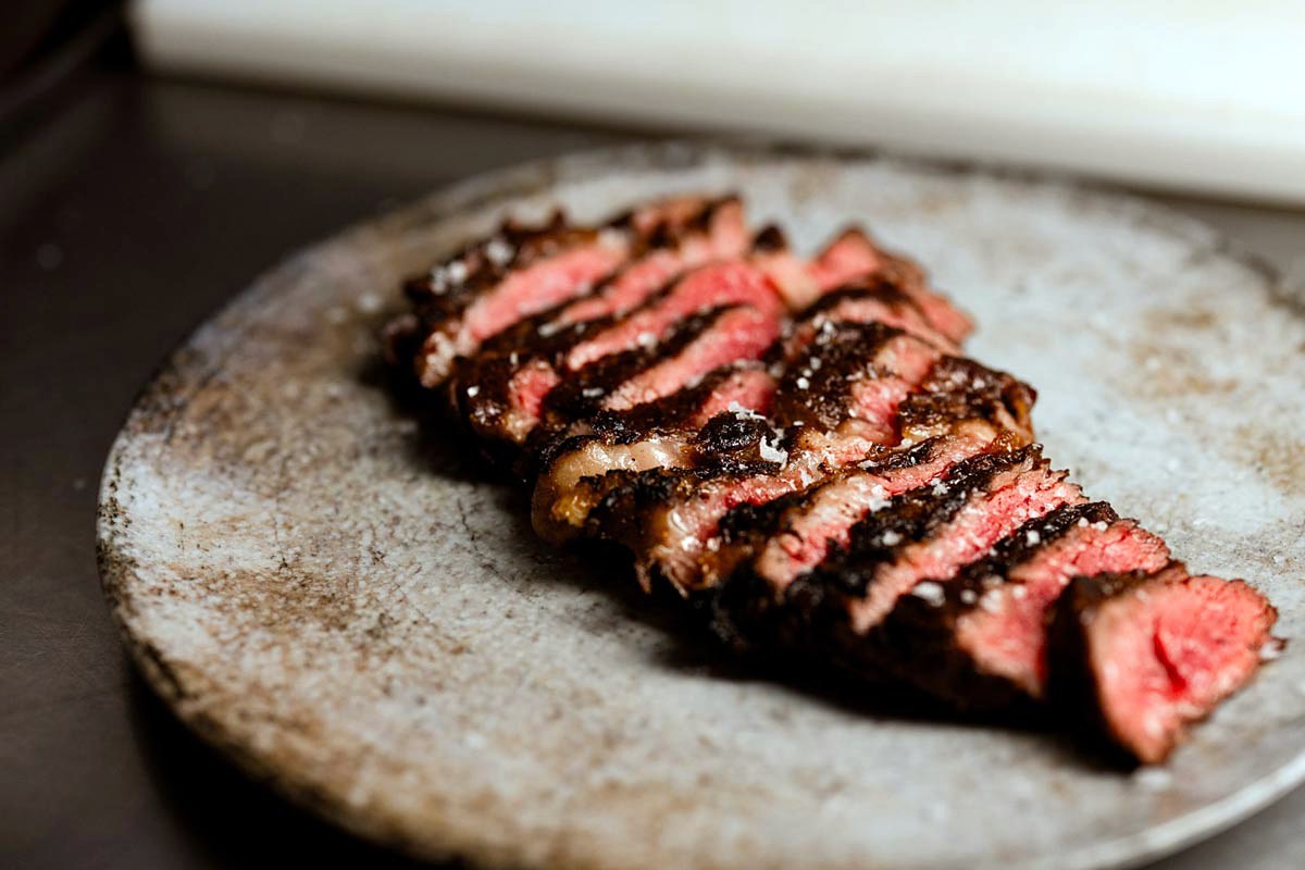 Sliced dry-aged steak at Ménage