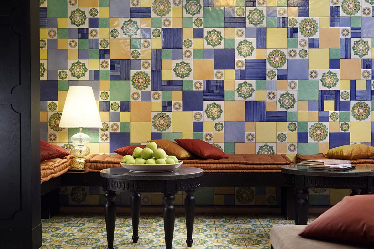 Lounge corner with a wall of Sicilian majolica tiles at Palace Catania