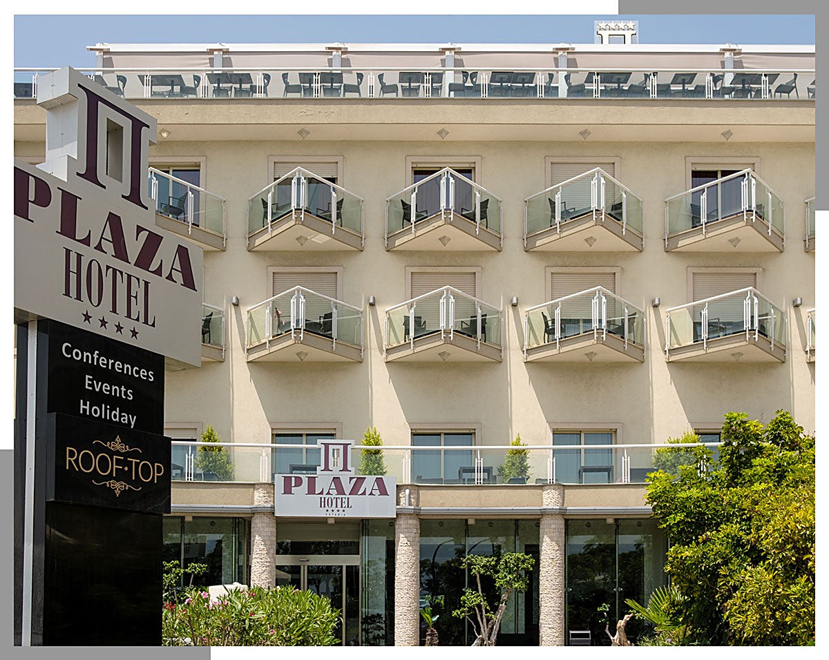 Façade of Plaza Hotel Catania with balconies and its sign