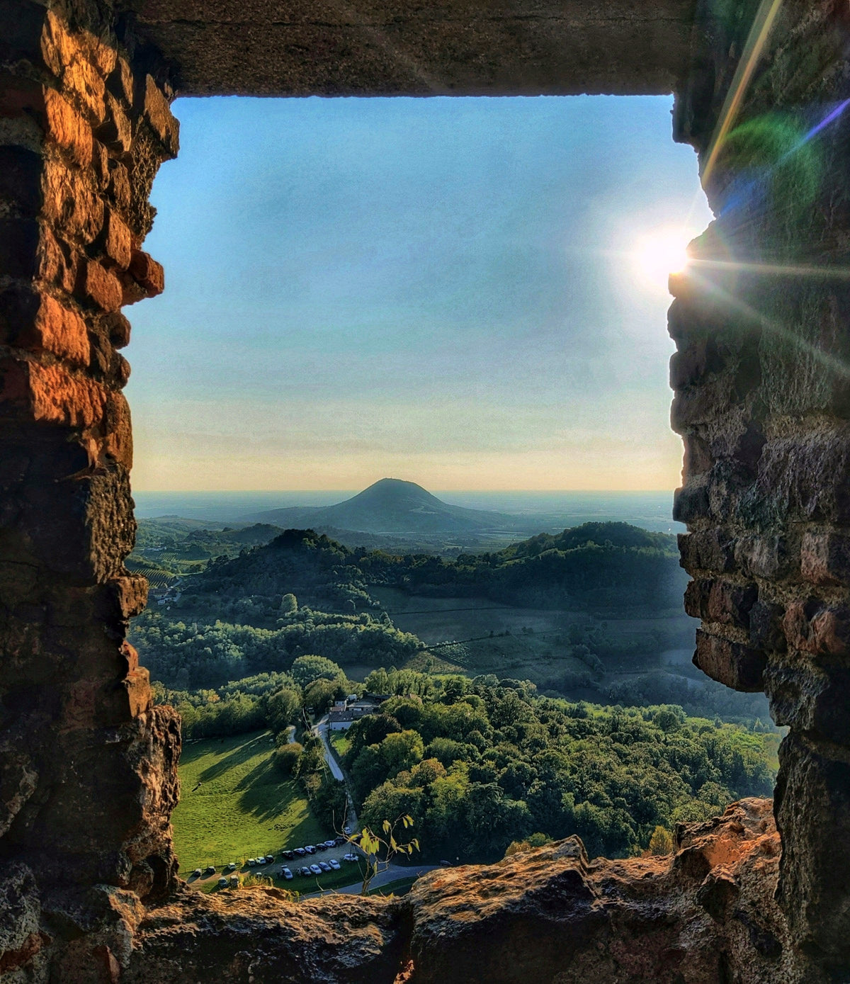 The hills seen through a window of Castello di Speronella