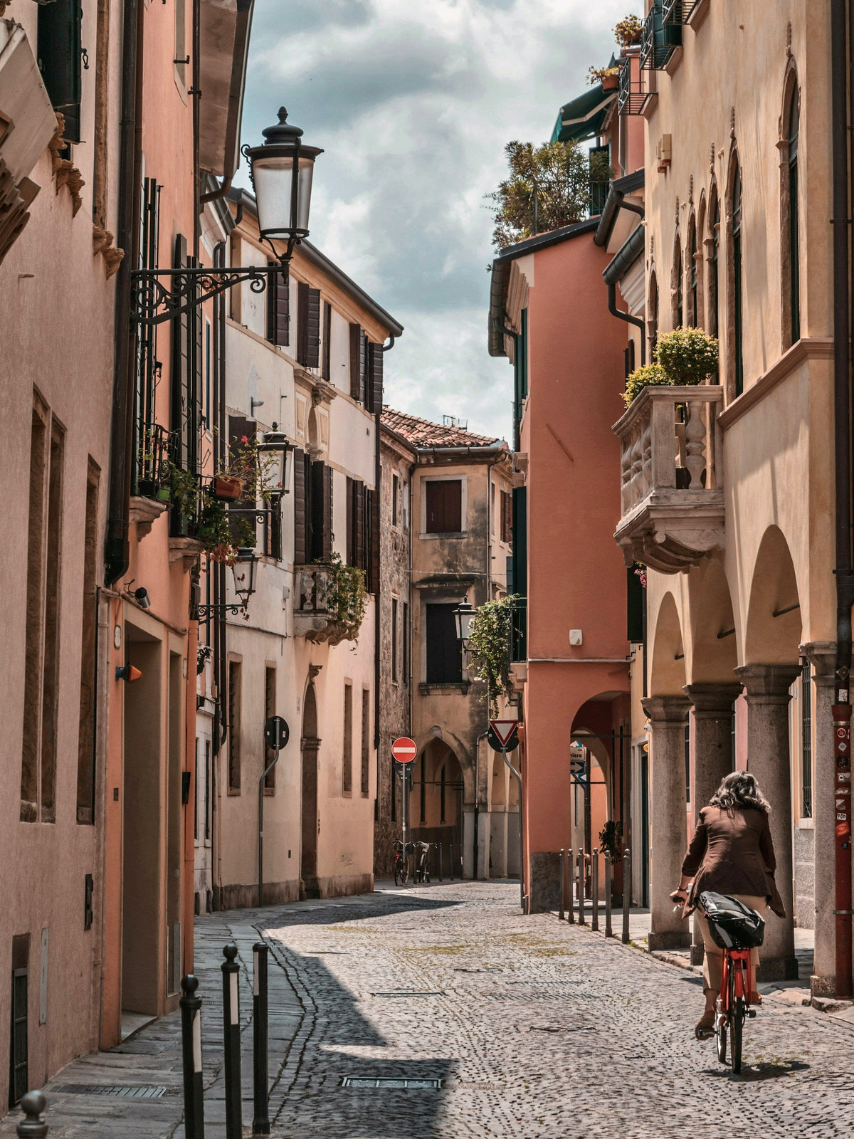 Cycling down a cobbled street in the old town