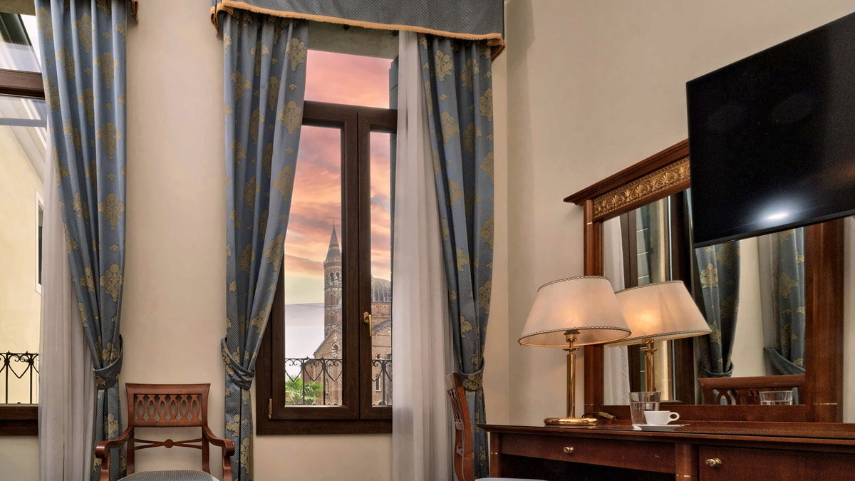 Panoramic room at Hotel Donatello with a view of the Basilica of Saint Anthony at sunset