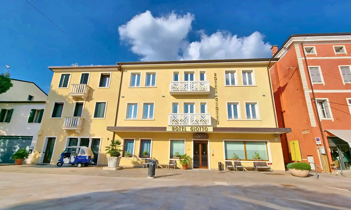 Yellow facade of Hotel Giotto on Piazzale Pontecorvo, Padua