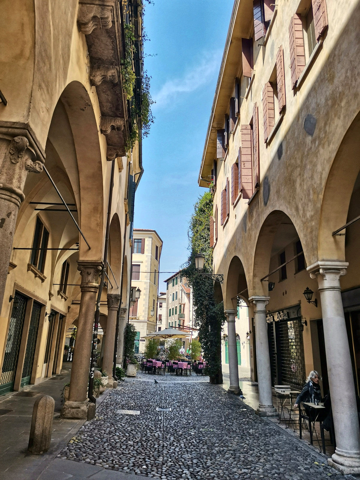 A cobbled street under the porticoes of the old town
