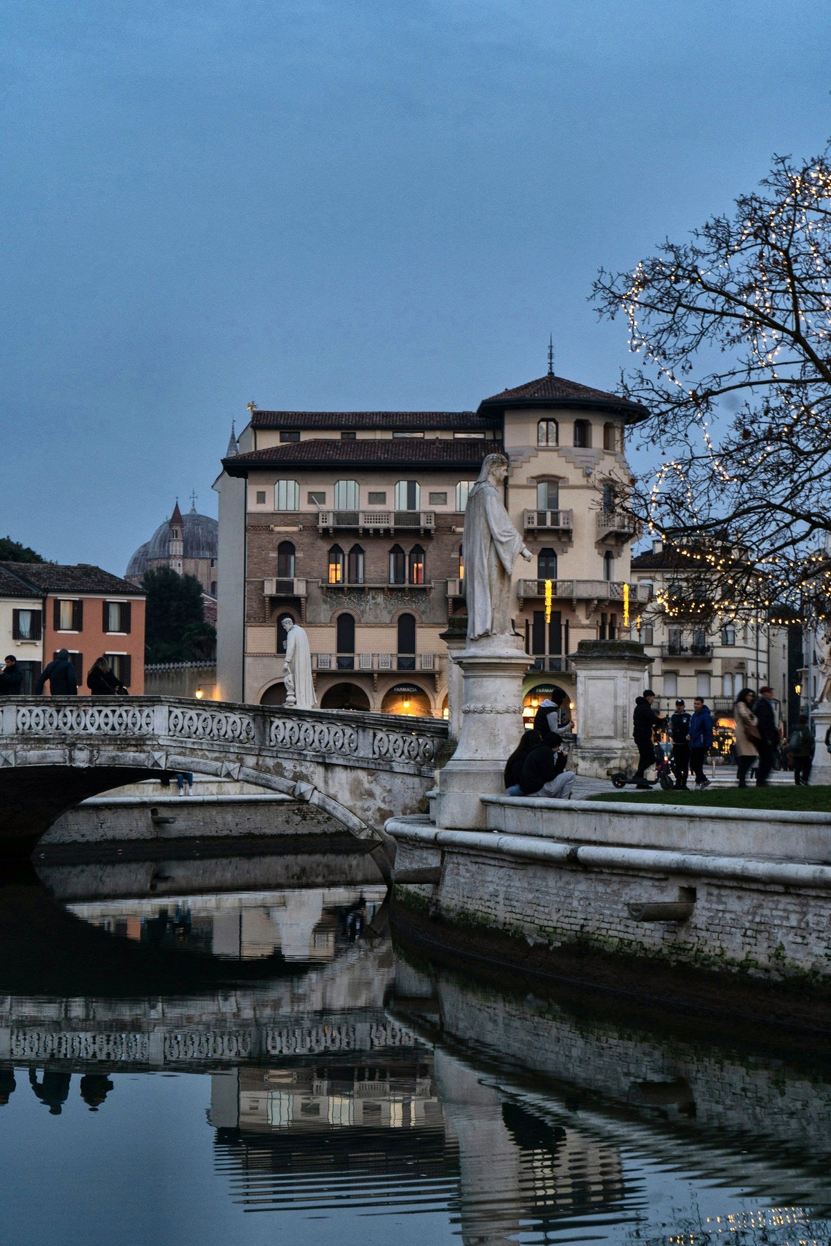 An evening stroll on a bridge of Prato della Valle at blue hour