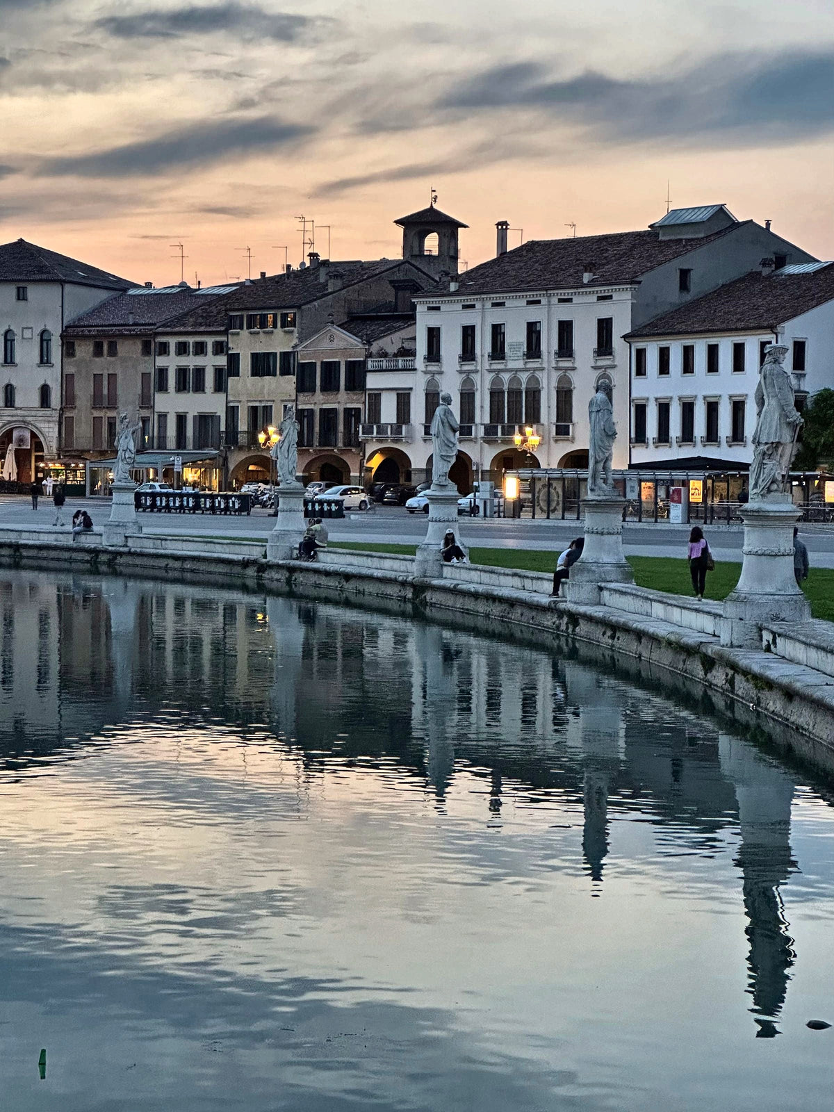 Dusk light over the houses and statues of Prato della Valle