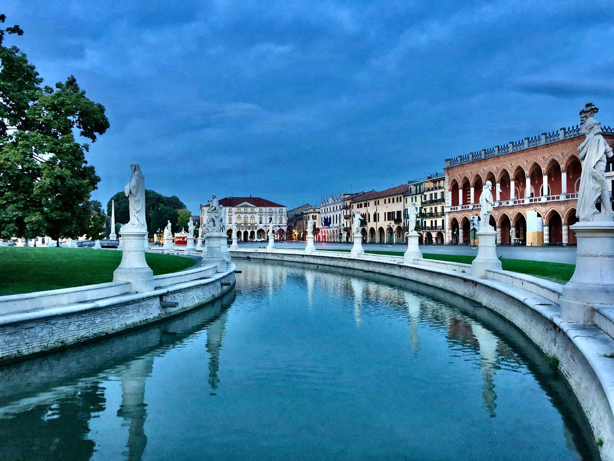 Prato della Valle in the evening, statues lining the curving canal