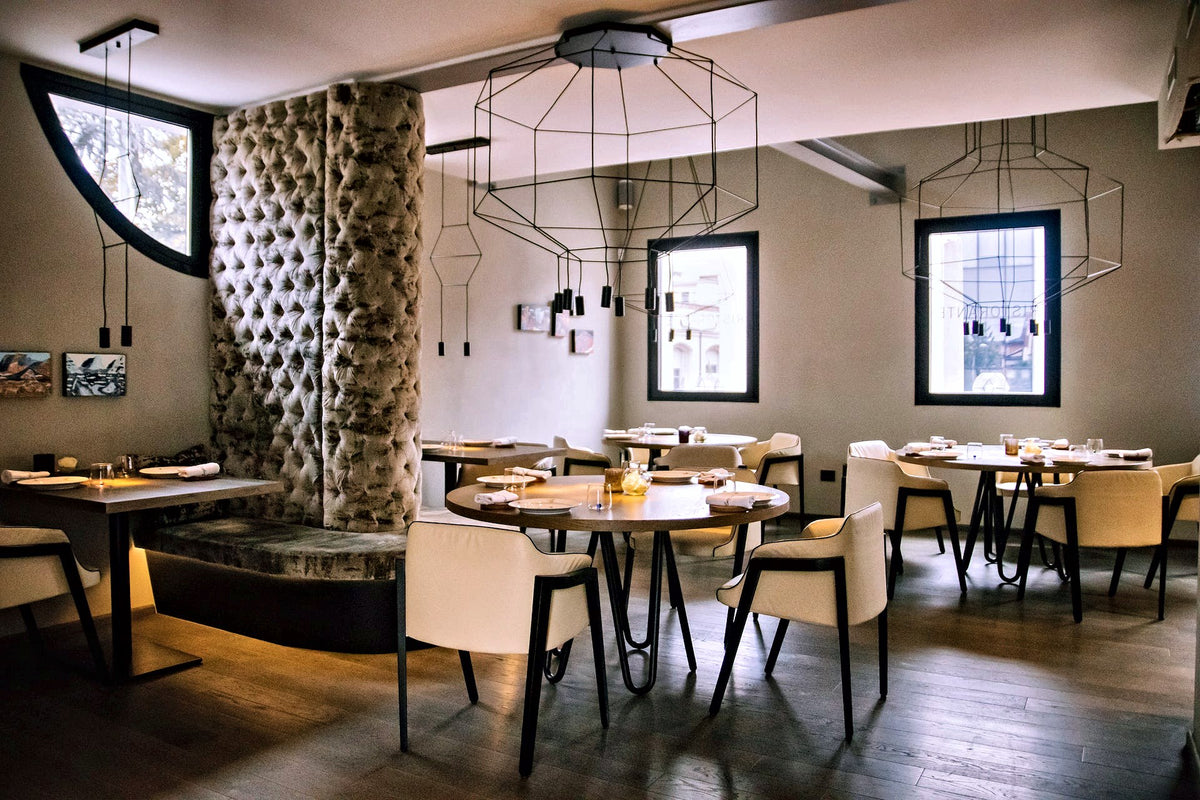 Dining room with sculptural pendant lights at Tola Rasa, Padua