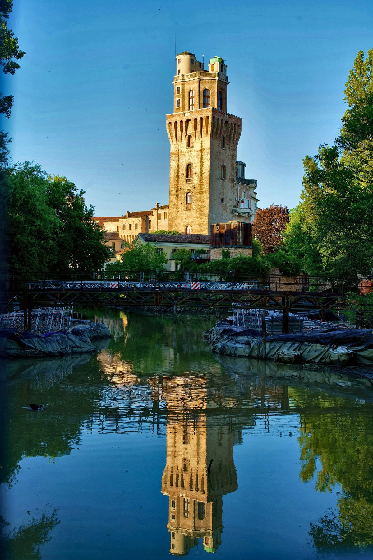 La Specola tower reflected in the river