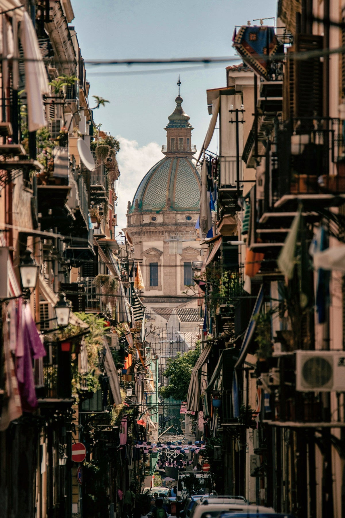 The cathedral glimpsed at the end of a narrow street of balconies