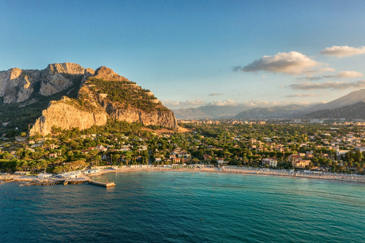 Turquoise water and limestone cliffs in the bay of Mondello