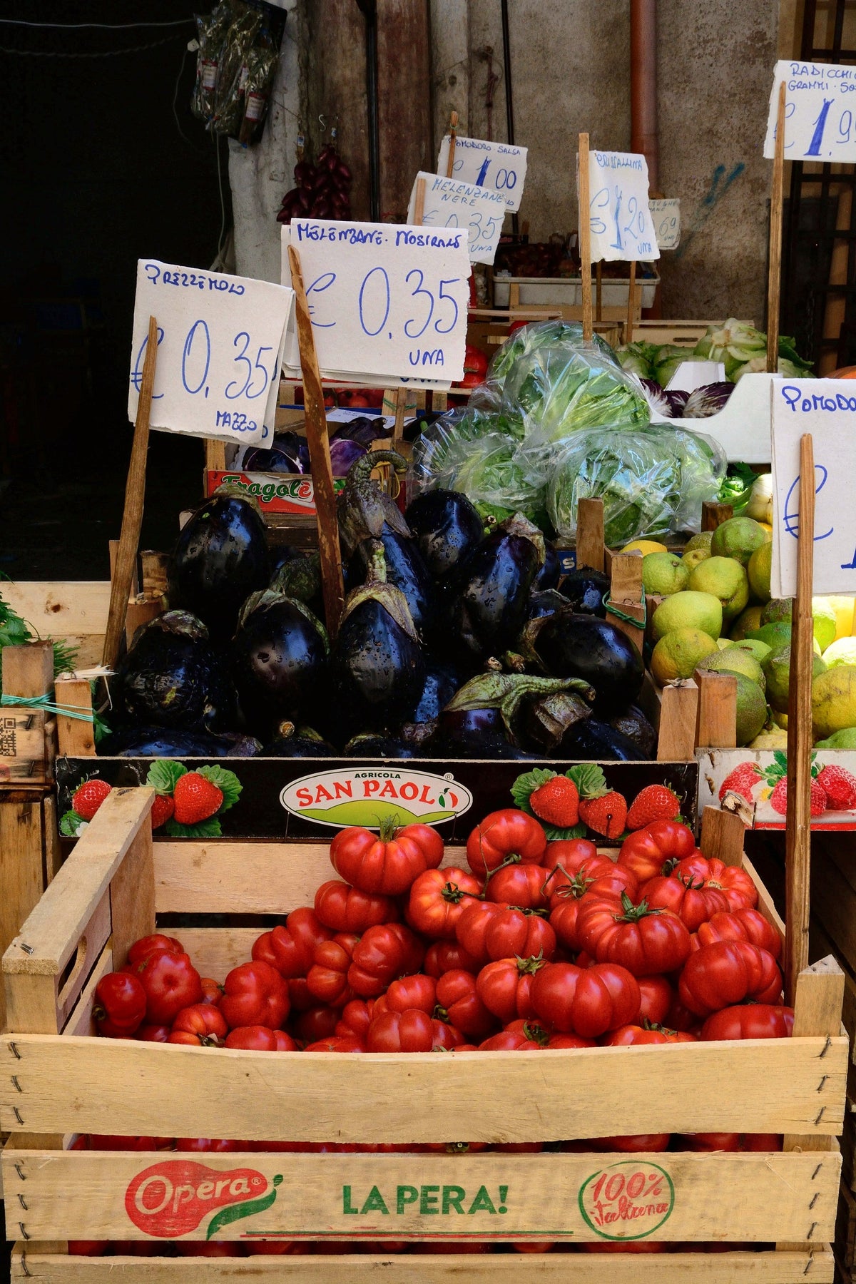 Tomatoes, aubergines and greens at a Palermo grocer