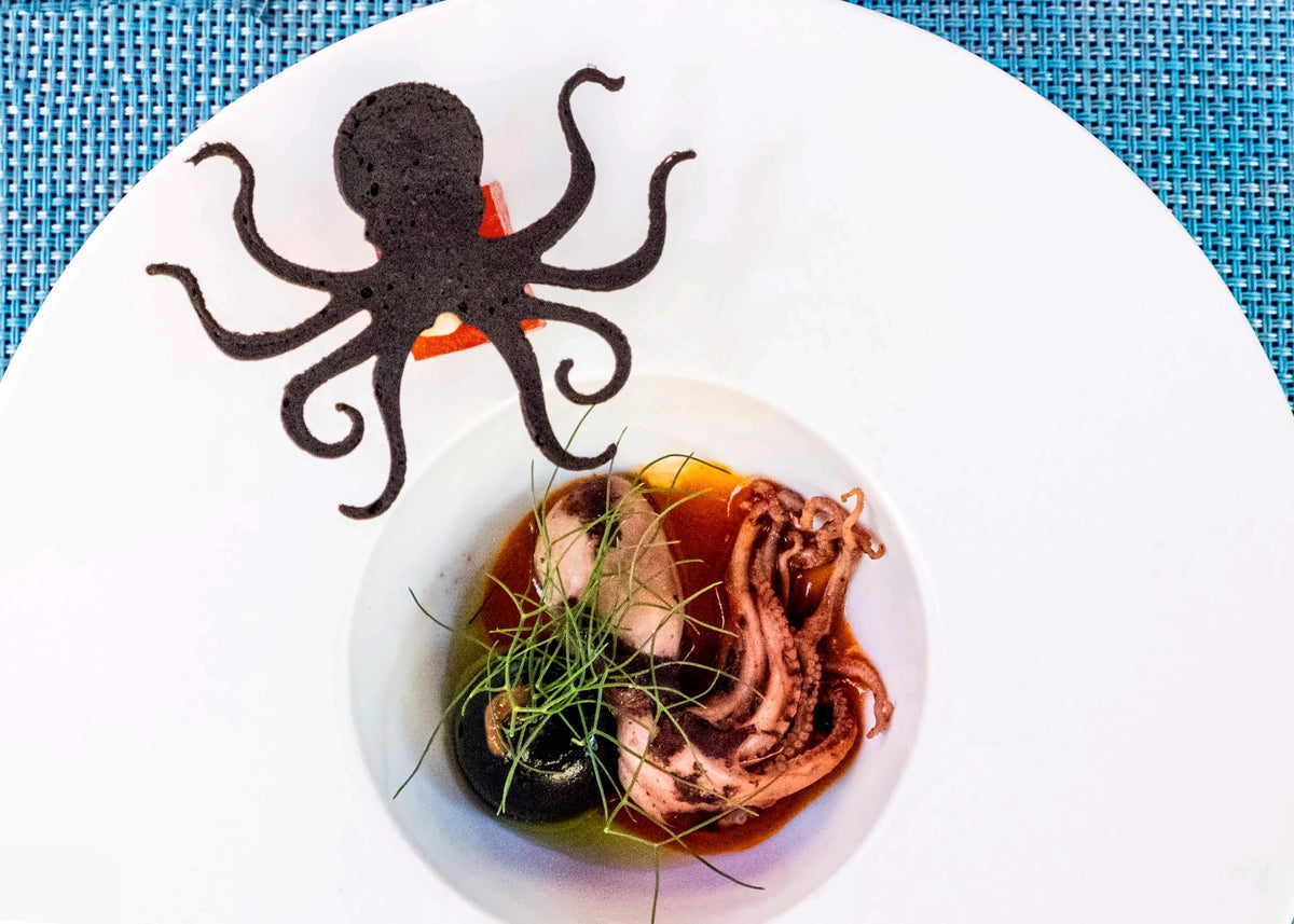 An octopus dish on a blue table at Aja Mola