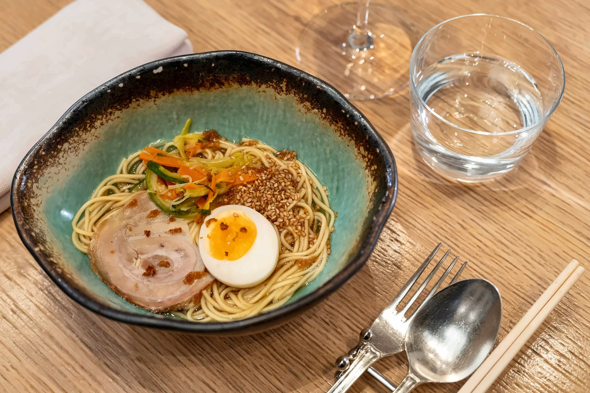 A bowl of noodle soup with egg at Bye Bye Blues