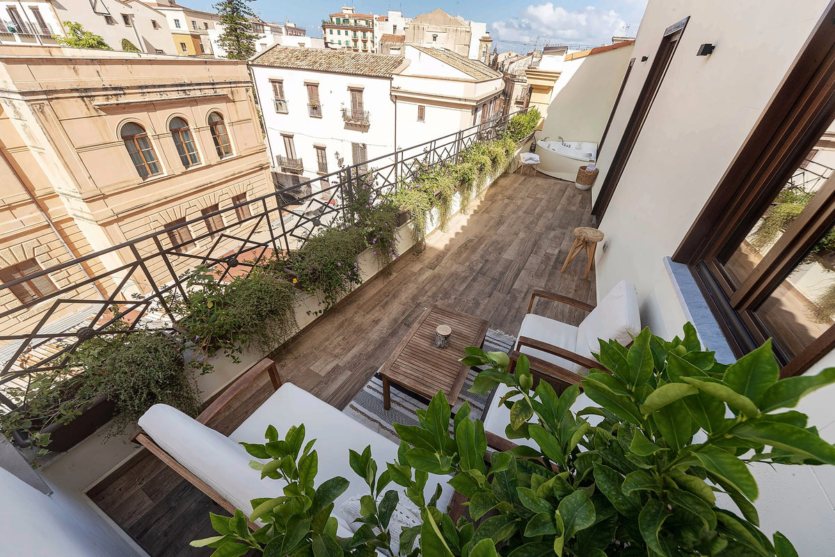 A planted terrace over the rooftops at Casa Nostra Boutique Hotel