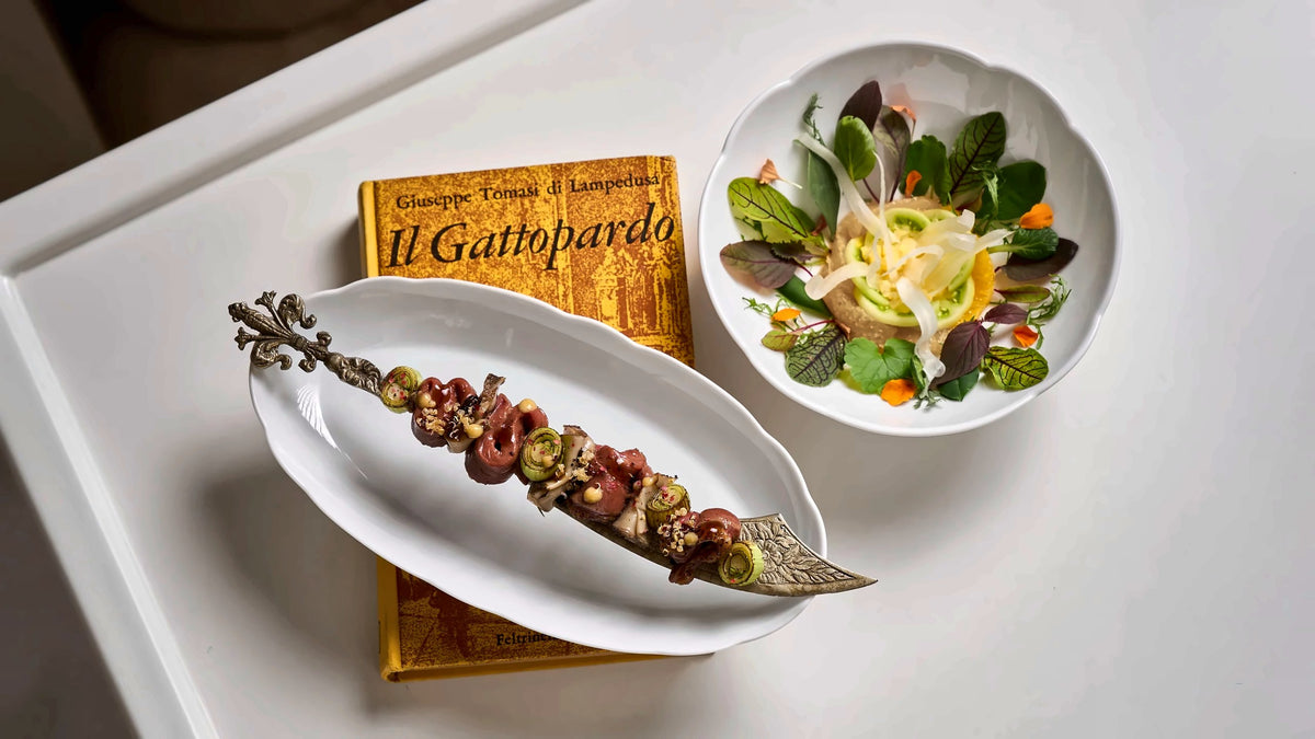 A beccafico dish served beside a copy of Il Gattopardo at Charleston