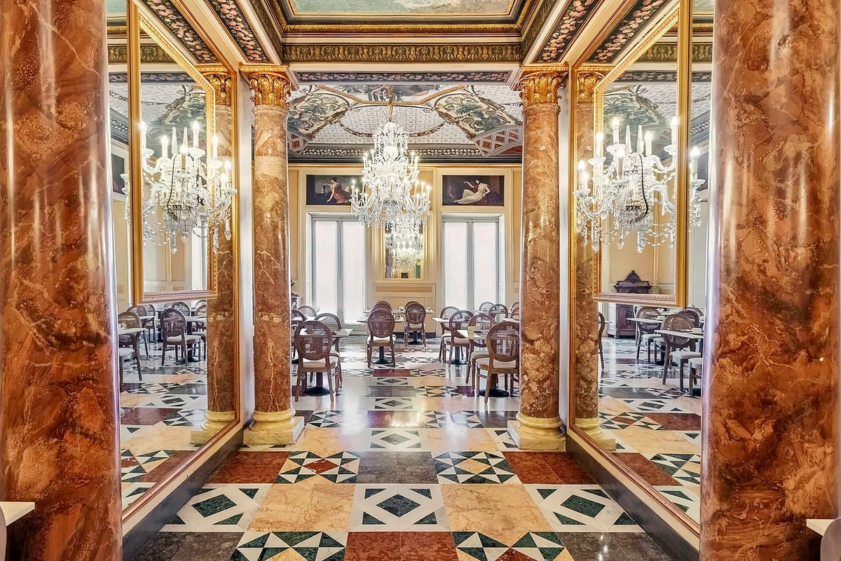Marble columns and chandeliers in a hall of Eurostars Centrale Palace