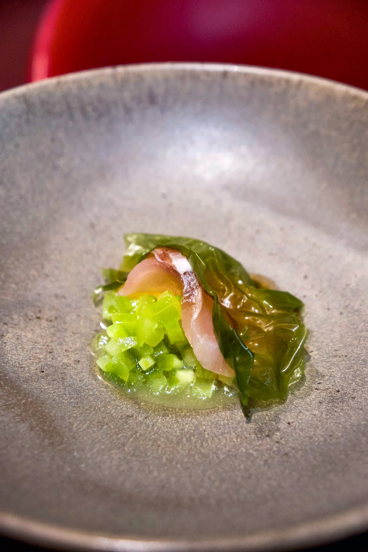 A raw fish course in a stoneware bowl at Gagini