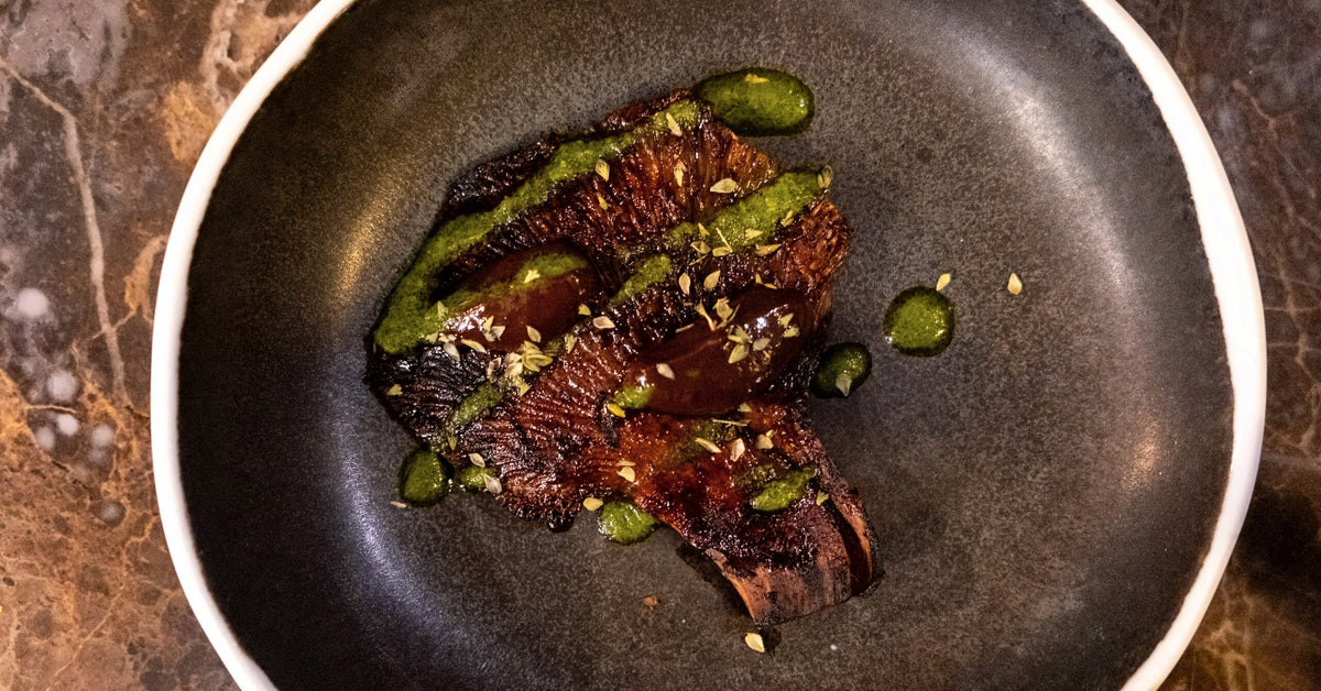 A glazed dish with a green sauce at Gagini