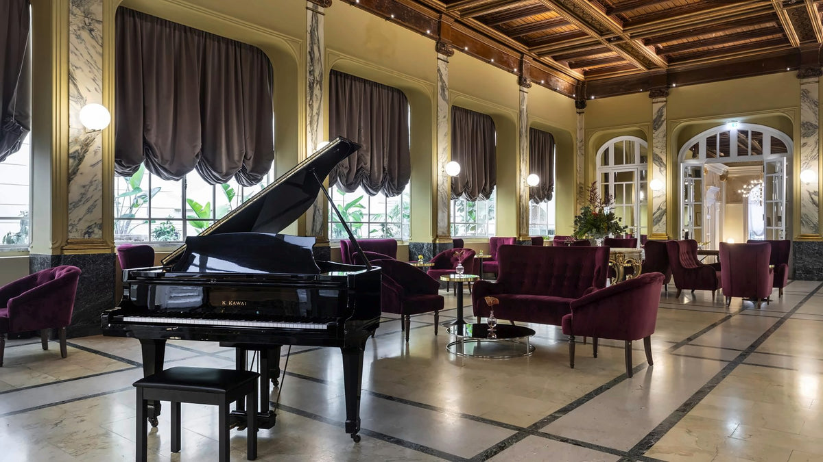 The winter garden with a grand piano at Grand Hotel et des Palmes