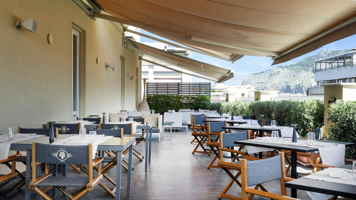 The terrace restaurant of Grand Hotel et des Palmes with a view of the hills