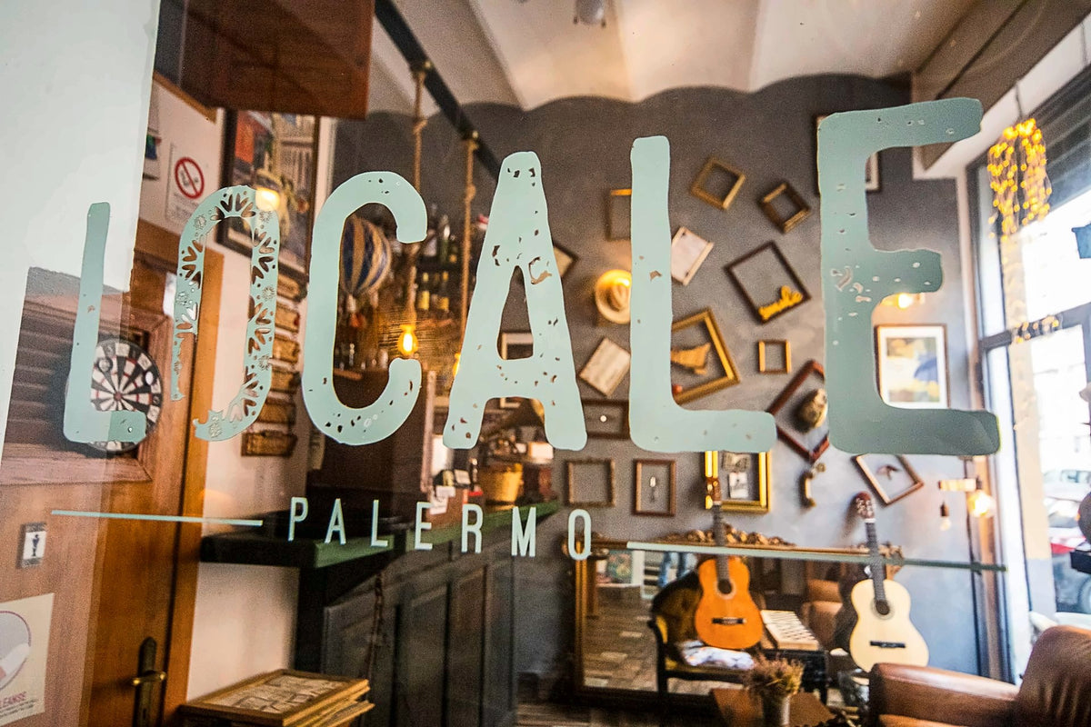 Vintage frames and guitars on the walls of Locale Palermo