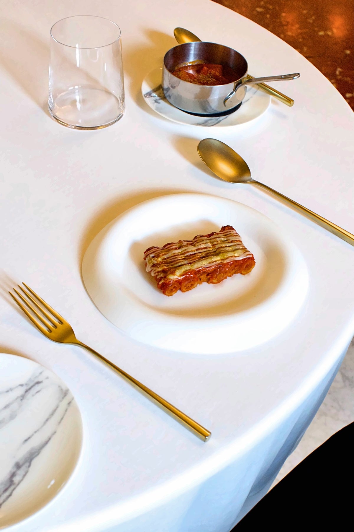 A plated course with gold cutlery at Mec Restaurant