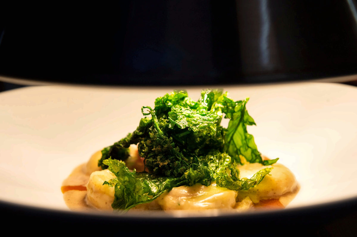 A dish crowned with crisp greens at Osteria Ballarò
