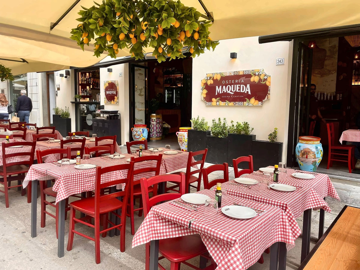 Checked tablecloths under the lemon tree on the terrace of Osteria Maqueda