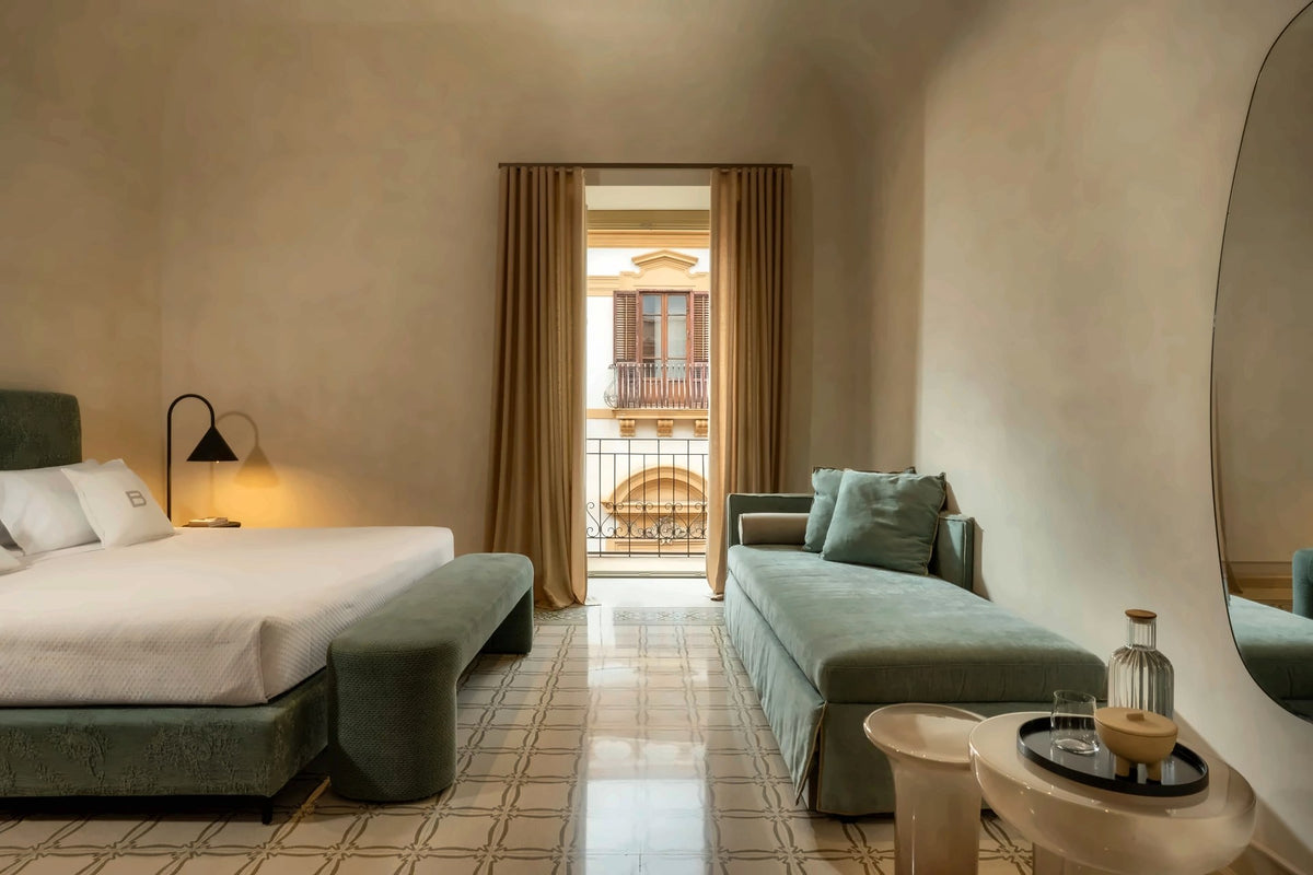 A room at Palazzo Balsamo with tiled floor and a balcony door