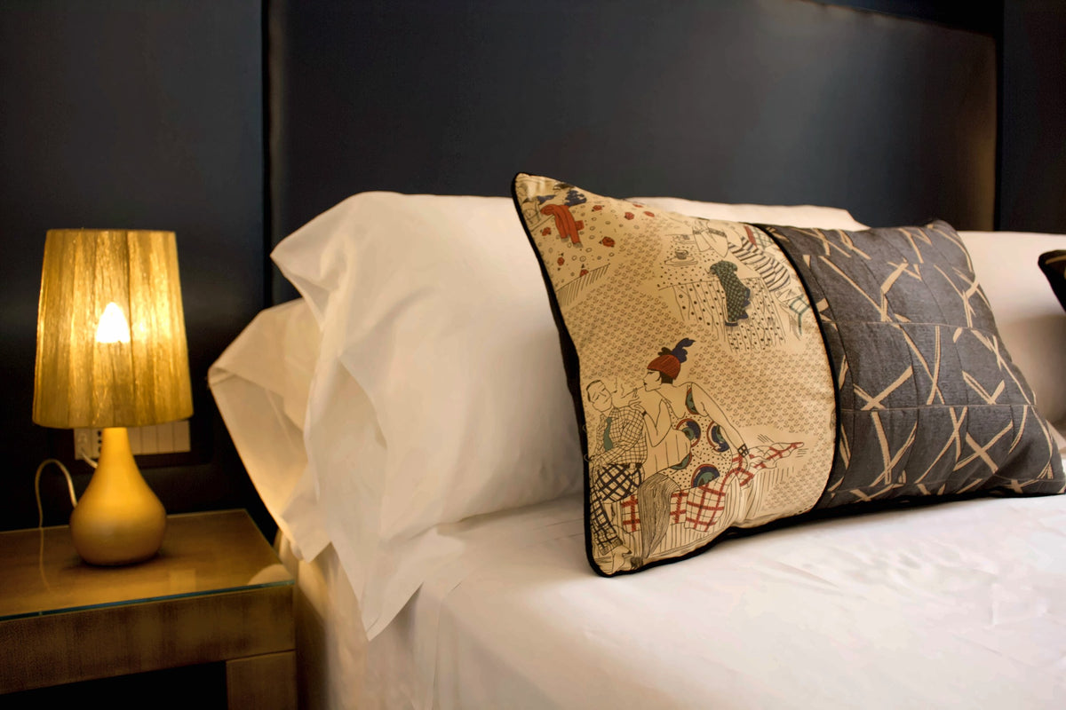 A bedroom with embroidered cushions at Palazzo Cartari