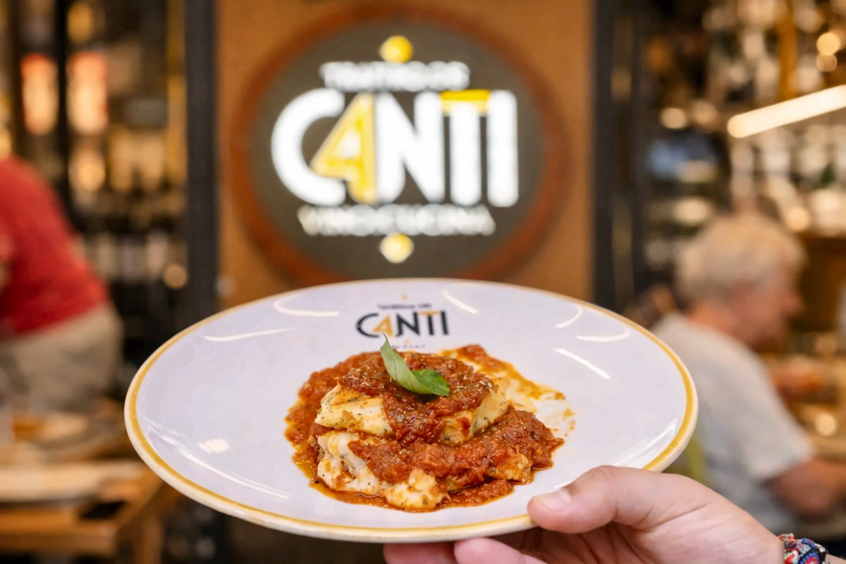 A plate of pasta held up inside Taverna dei Canti