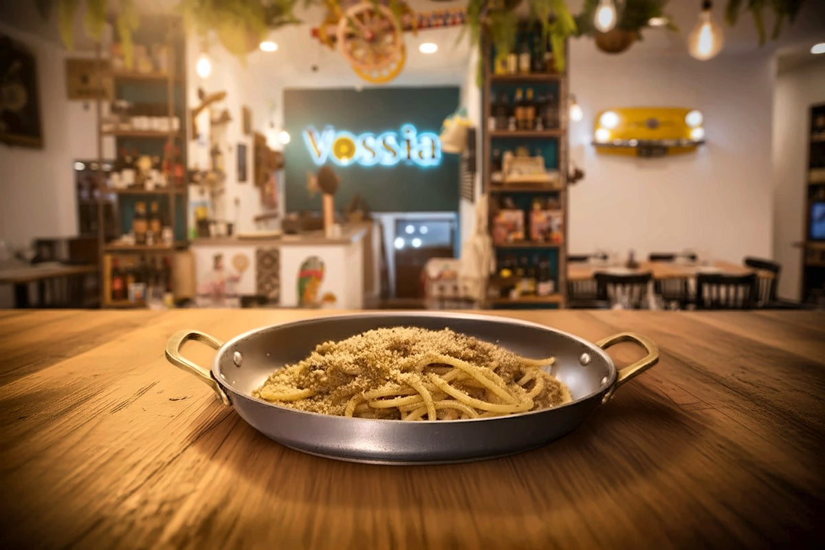 A pan of pasta with toasted breadcrumbs at Vossìa