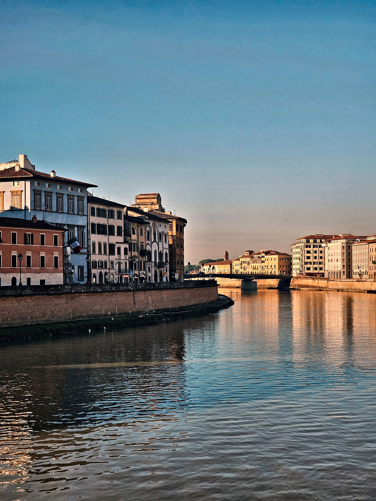 Dusk along the Arno, the bridges lined up towards the sea