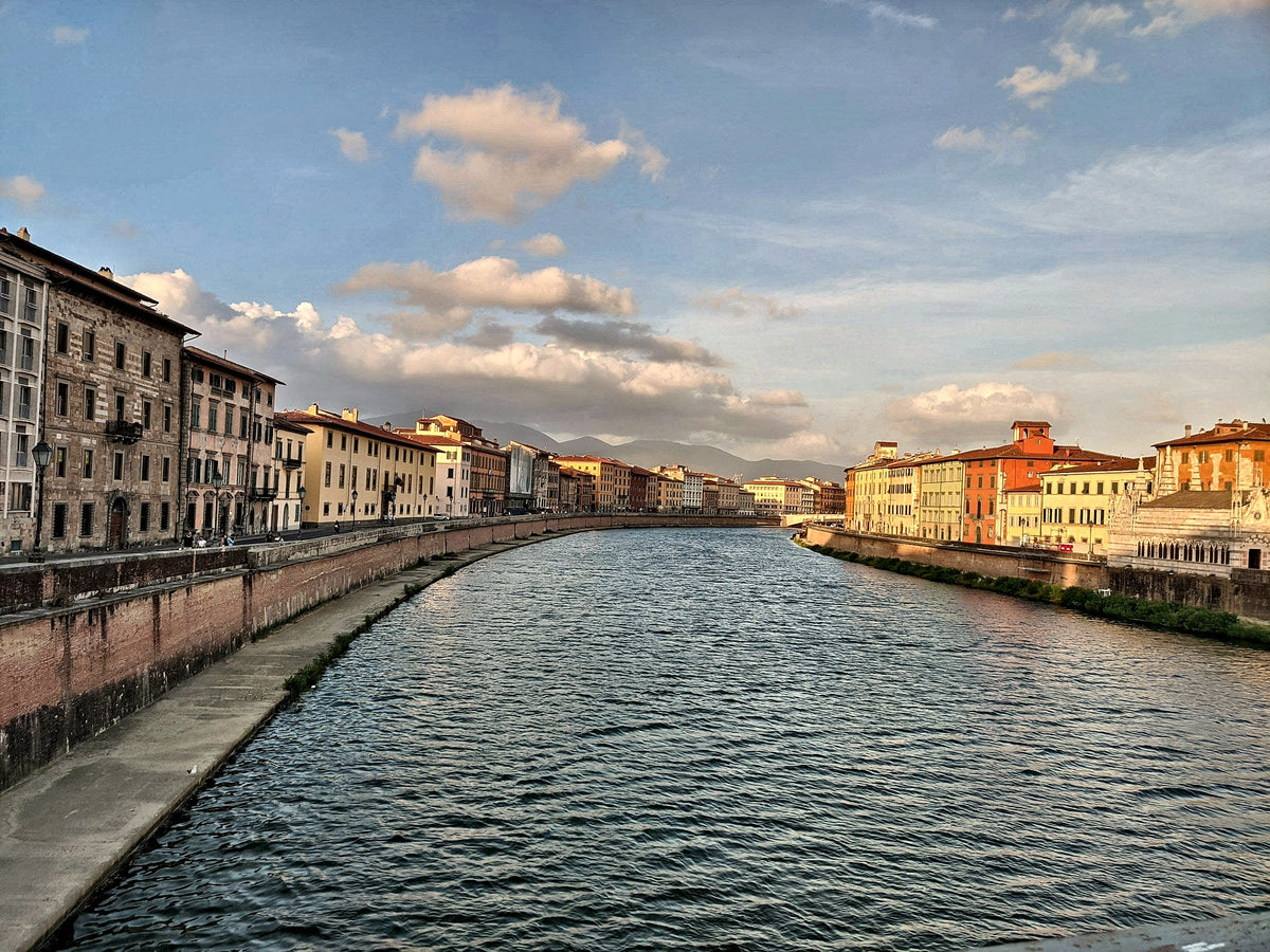 Late light on the curve of the Arno and its pastel riverside houses