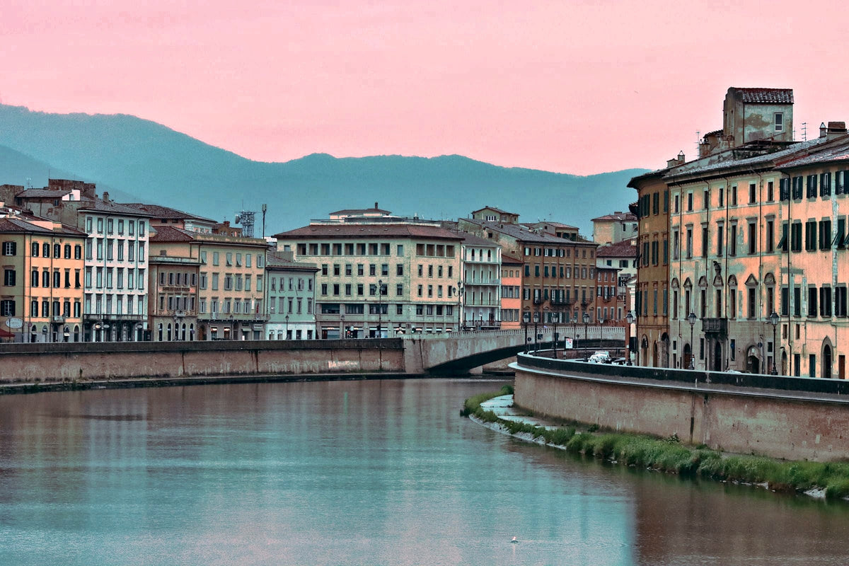Pink dusk over the Arno, the hills fading behind the palazzi